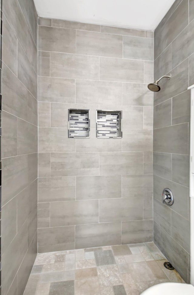 bathroom with tiled shower