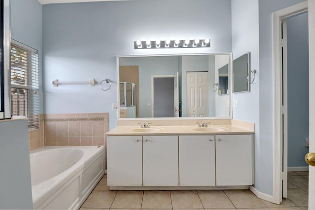 bathroom with tile patterned flooring, vanity, and separate shower and tub