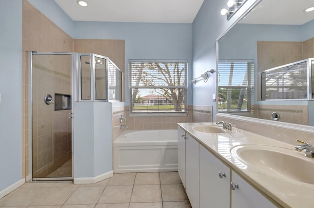 bathroom featuring tile patterned flooring, vanity, and separate shower and tub