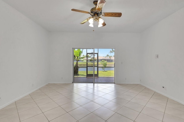 8620 Pine Cay, West Palm Beach, FL 33411 - unfurnished room featuring ceiling fan, a water view, light tile patterned floors, and baseboards