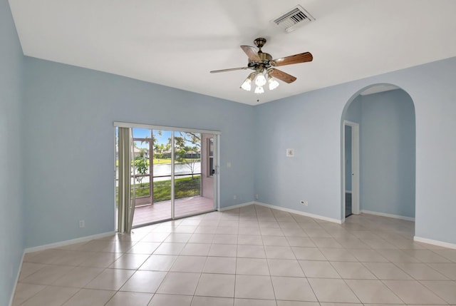 tiled empty room with ceiling fan