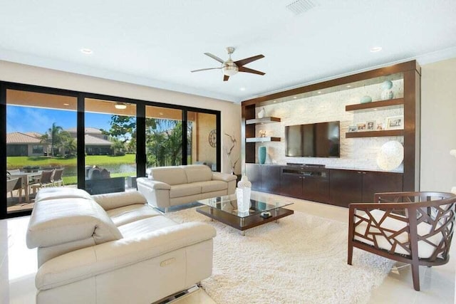 living room featuring built in shelves, ceiling fan, and ornamental molding