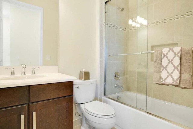 full bathroom with vanity, toilet, and enclosed tub / shower combo