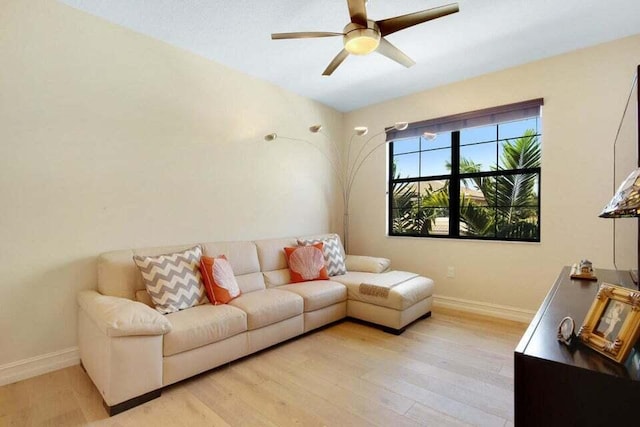 living room with light wood-type flooring and ceiling fan