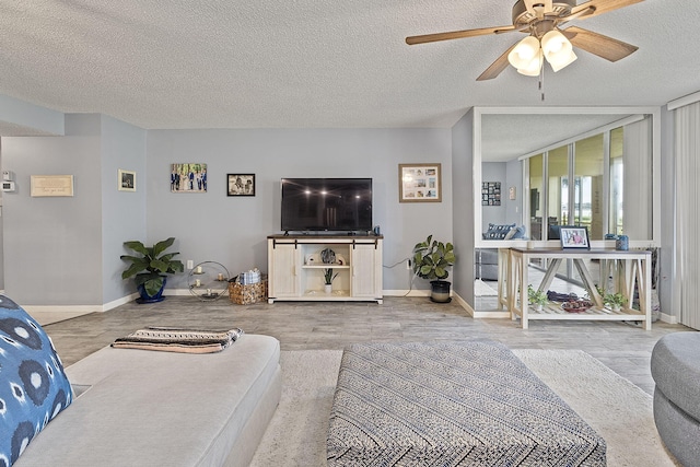 living room with ceiling fan, hardwood / wood-style floors, and a textured ceiling