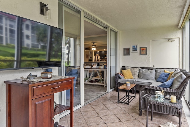 sunroom / solarium featuring ceiling fan