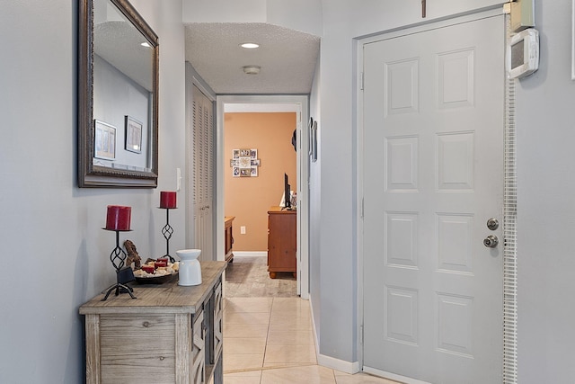 hall featuring light tile patterned floors