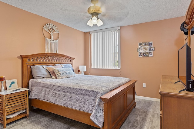 bedroom featuring ceiling fan, light hardwood / wood-style flooring, and a textured ceiling