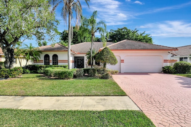 mediterranean / spanish-style home with a garage and a front yard