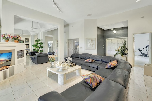 living room with ceiling fan, light tile patterned floors, and a fireplace