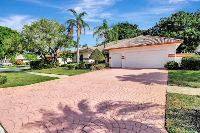 view of front of home with a garage and a front yard