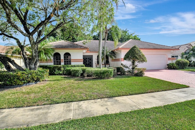 view of front of house with a garage and a front lawn