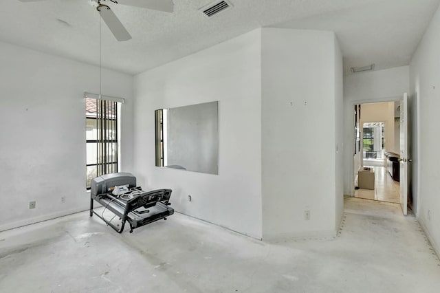 unfurnished room featuring a wealth of natural light and ceiling fan