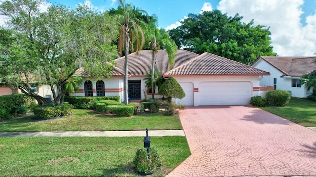 view of front of house featuring a garage and a front lawn