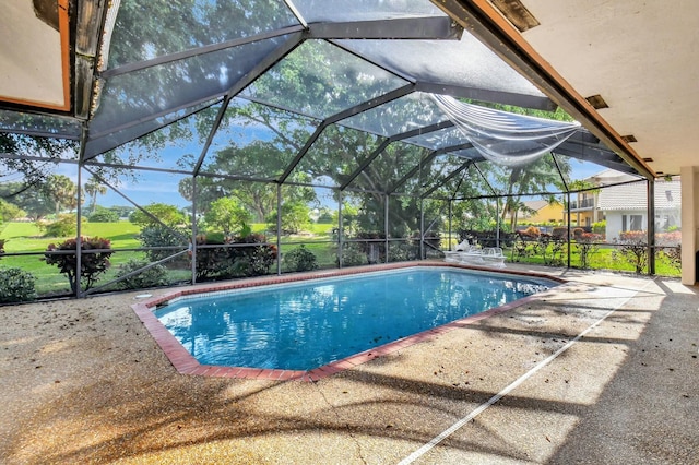 view of swimming pool with glass enclosure and a patio area