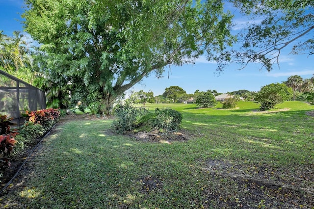 view of yard featuring glass enclosure