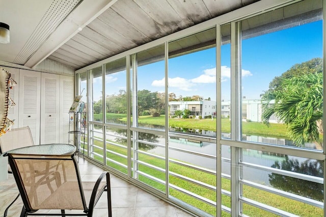 unfurnished sunroom with a water view and a healthy amount of sunlight