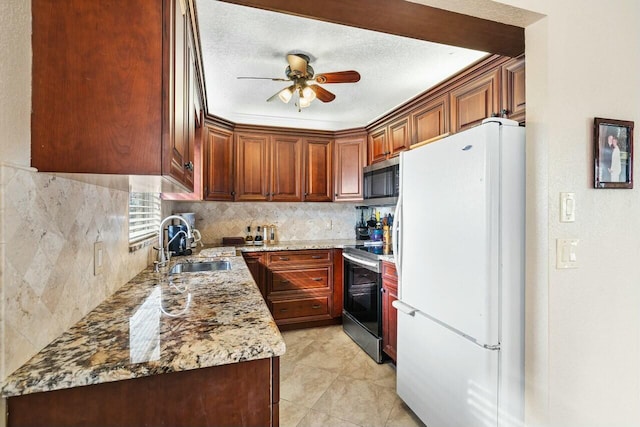 kitchen featuring sink, ceiling fan, light stone countertops, a textured ceiling, and appliances with stainless steel finishes