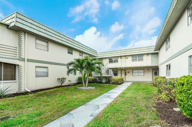 view of property's community with a lawn