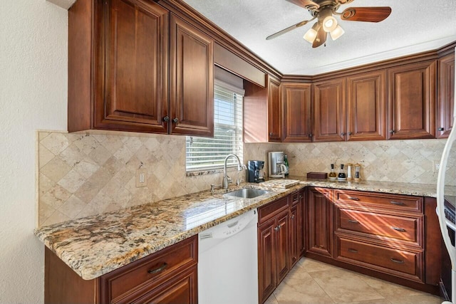 kitchen featuring light stone countertops, sink, ceiling fan, white dishwasher, and light tile patterned flooring