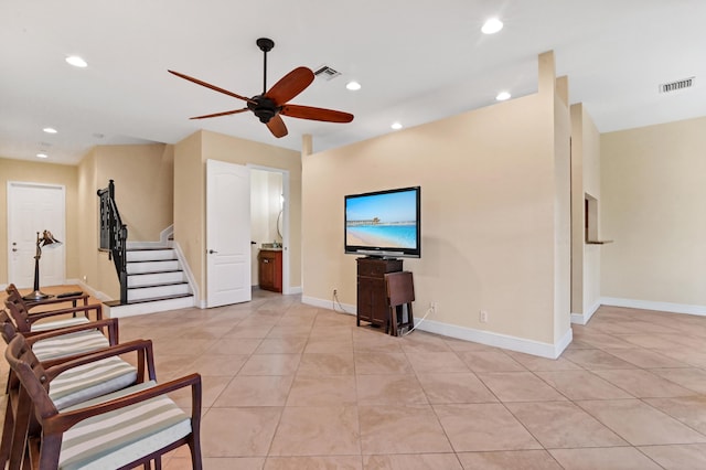 living room with ceiling fan and light tile patterned flooring