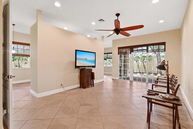 tiled living room featuring ceiling fan