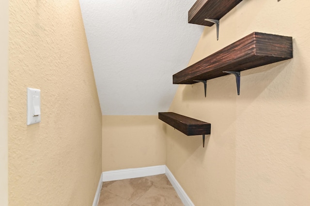 walk in closet with lofted ceiling