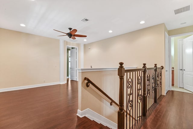 hallway with dark hardwood / wood-style flooring