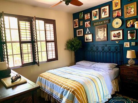 bedroom with ceiling fan and multiple windows