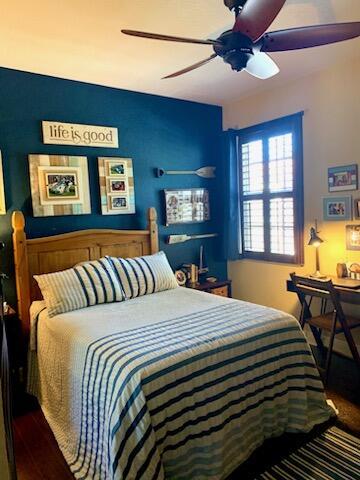 bedroom featuring wood-type flooring and ceiling fan