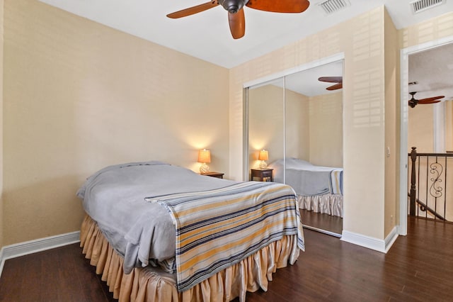 bedroom with ceiling fan, dark hardwood / wood-style flooring, and a closet