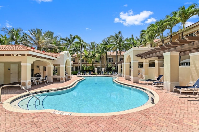 view of pool with a pergola and a patio