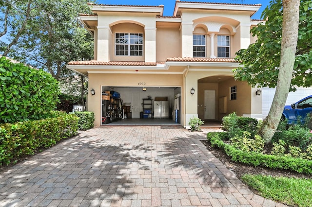 mediterranean / spanish-style home with a garage