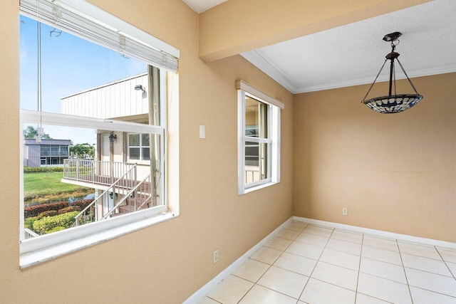 interior space featuring a textured ceiling, light tile patterned flooring, and crown molding