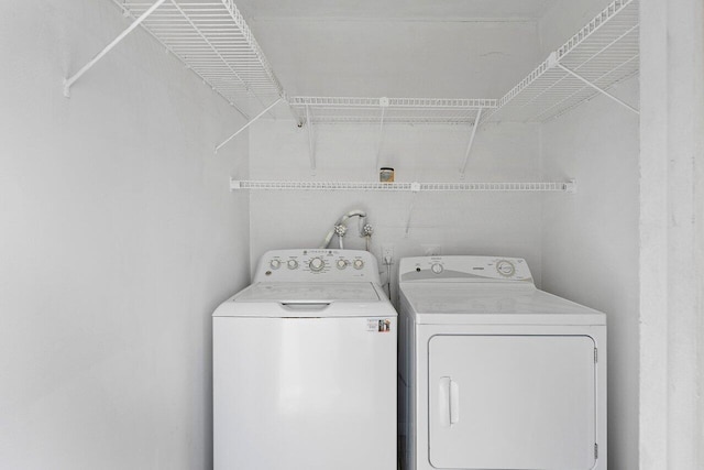 clothes washing area featuring independent washer and dryer