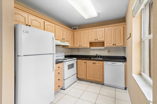 kitchen with white appliances, sink, light tile patterned floors, light brown cabinetry, and tasteful backsplash