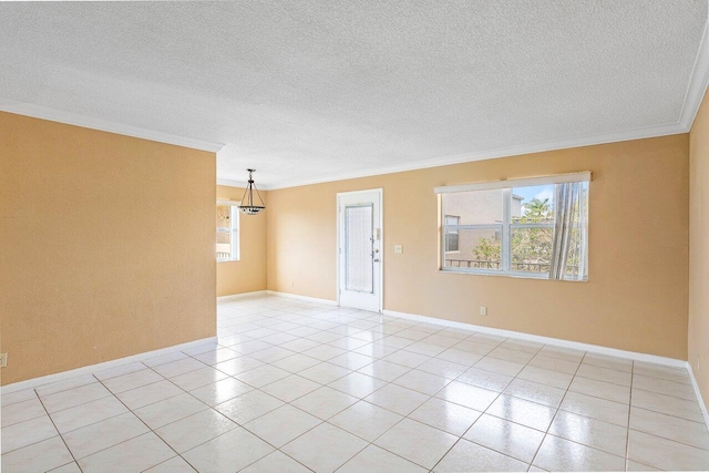 tiled spare room with ornamental molding and a textured ceiling