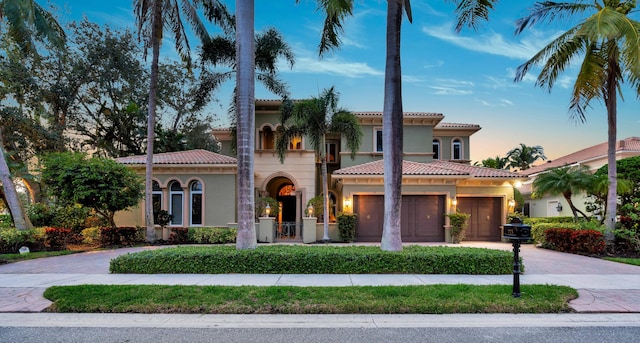 mediterranean / spanish home with a garage