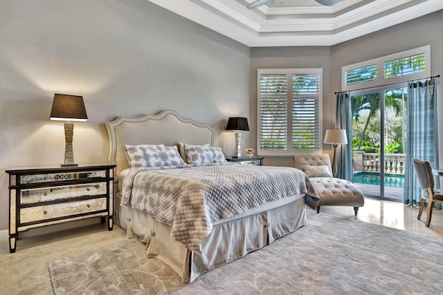 bedroom featuring access to exterior, a towering ceiling, and ornamental molding