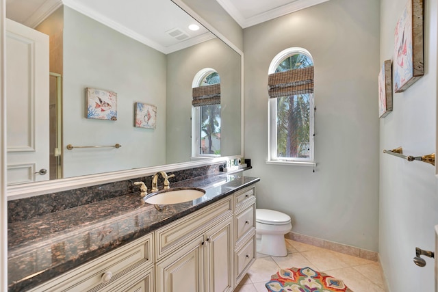 bathroom with tile patterned flooring, ornamental molding, vanity, and a healthy amount of sunlight