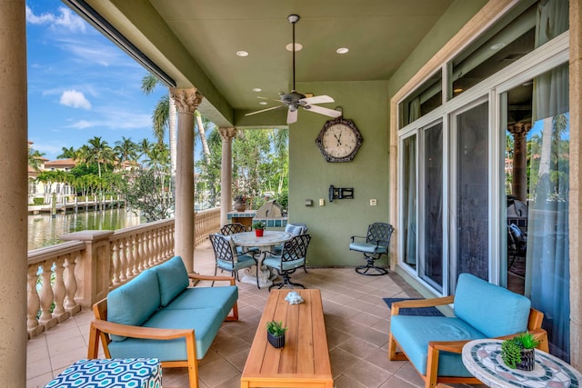 exterior space with ceiling fan and a water view