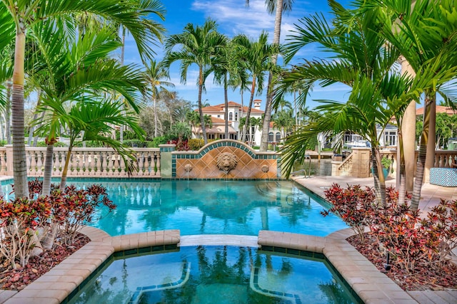 view of pool with an in ground hot tub