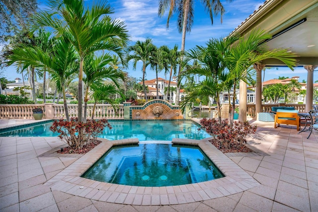 view of swimming pool with an in ground hot tub