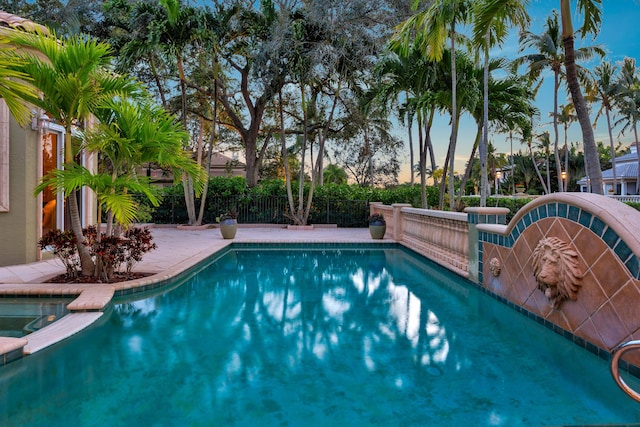 view of pool at dusk