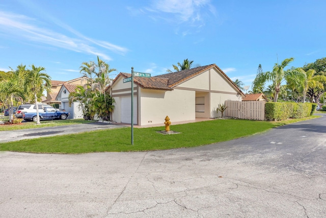 view of property exterior featuring a lawn and a garage