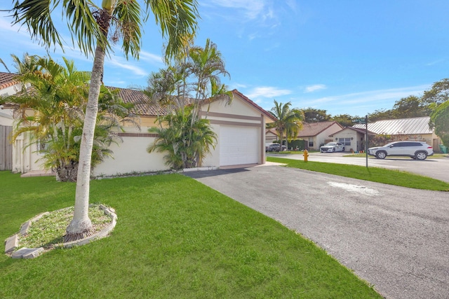 view of front of home featuring a garage and a front lawn