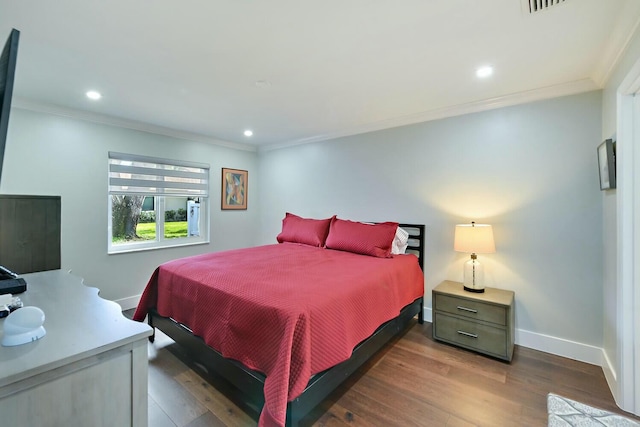 bedroom with dark hardwood / wood-style flooring and ornamental molding