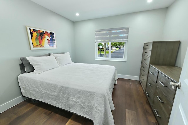 bedroom with dark hardwood / wood-style floors