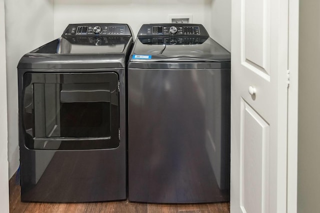 washroom featuring separate washer and dryer and dark hardwood / wood-style flooring