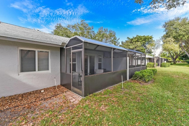 view of side of property with a lawn